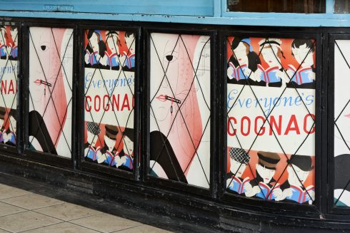 Lucy McKenzie, 'Everyone's Cognac (Advertising poster)' and 'Lipstick I (Advertising poster)', Sudbury Town station, 2020. Commissioned by Art on the Underground. Photo: GG Archard, 2020